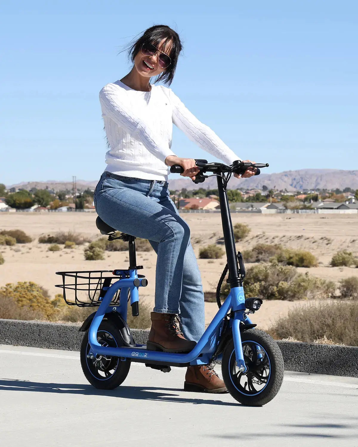woman commuting on a seated electric scooter along the road