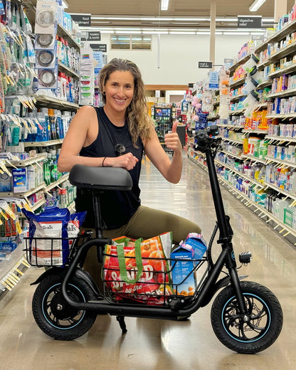 woman shopping with seated electric scooter in grocery store