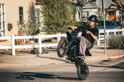 Gyroor GT54Pro electric dirt bike jumping over a dirt mound