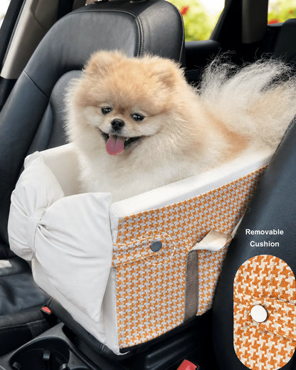 Small fluffy Pomeranian dog sitting in a removable cushion with orange and white houndstooth pattern in electric scooter backseat